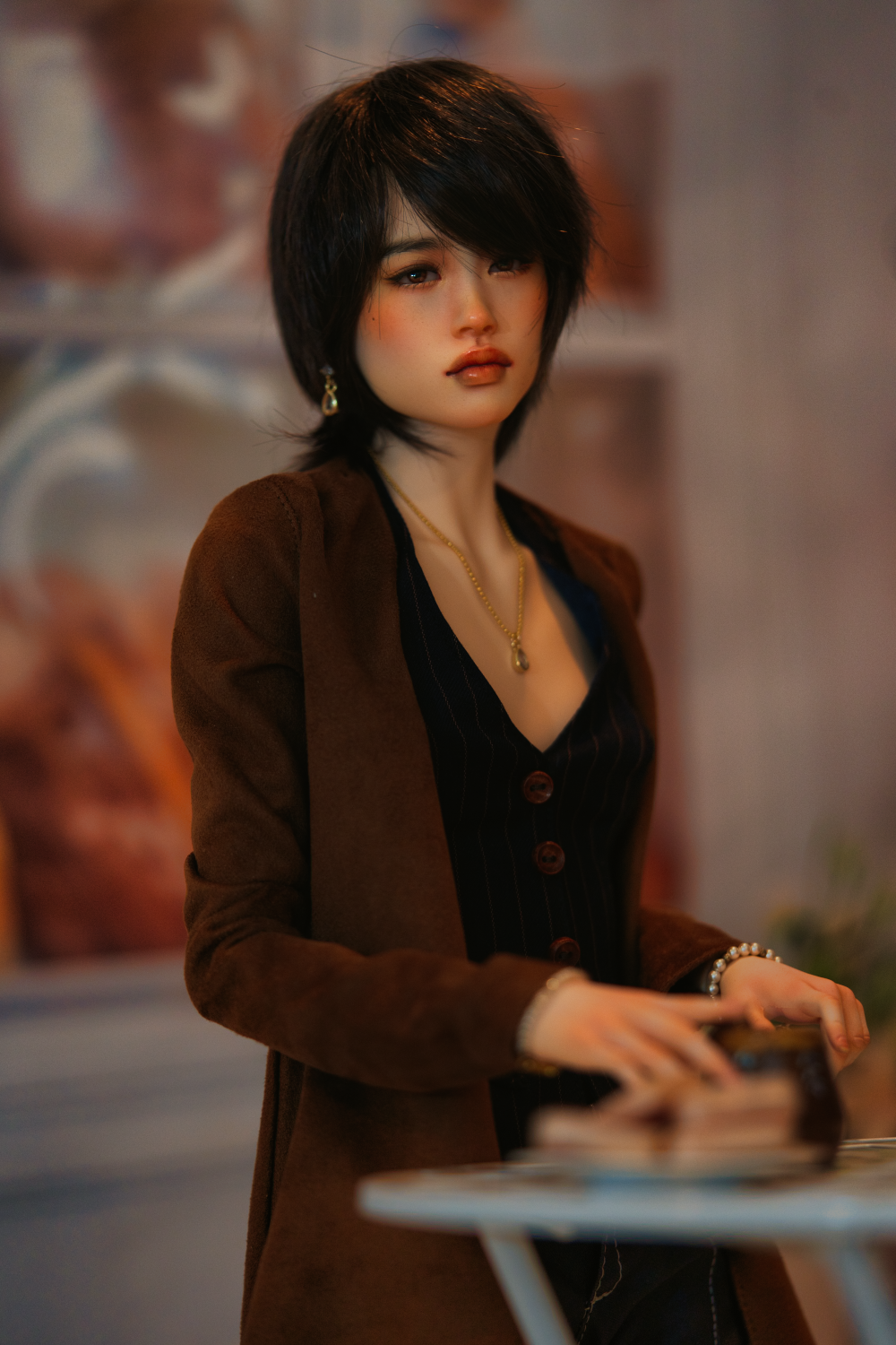 A female asian doll with deep red lips wearing a red head scarf